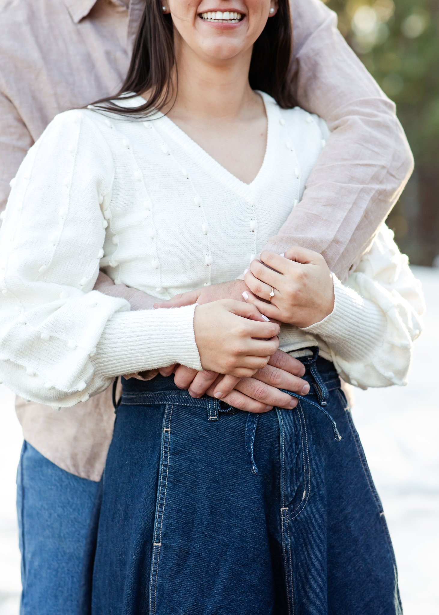 Julia and Jonas intertwine their hands during an embrace.