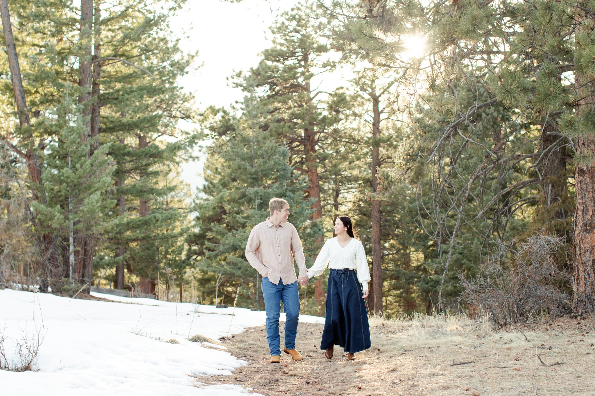 A walk through the pines, Jonas and Julia hold hands as they stroll.