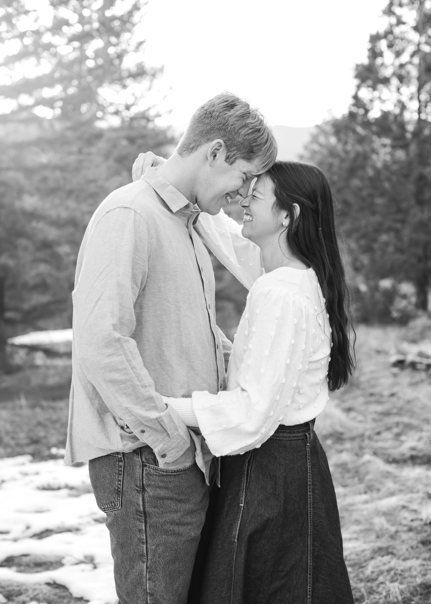 With foreheads touching, Jonas and Julia enjoy a close hug. Photo is black and white filtered.