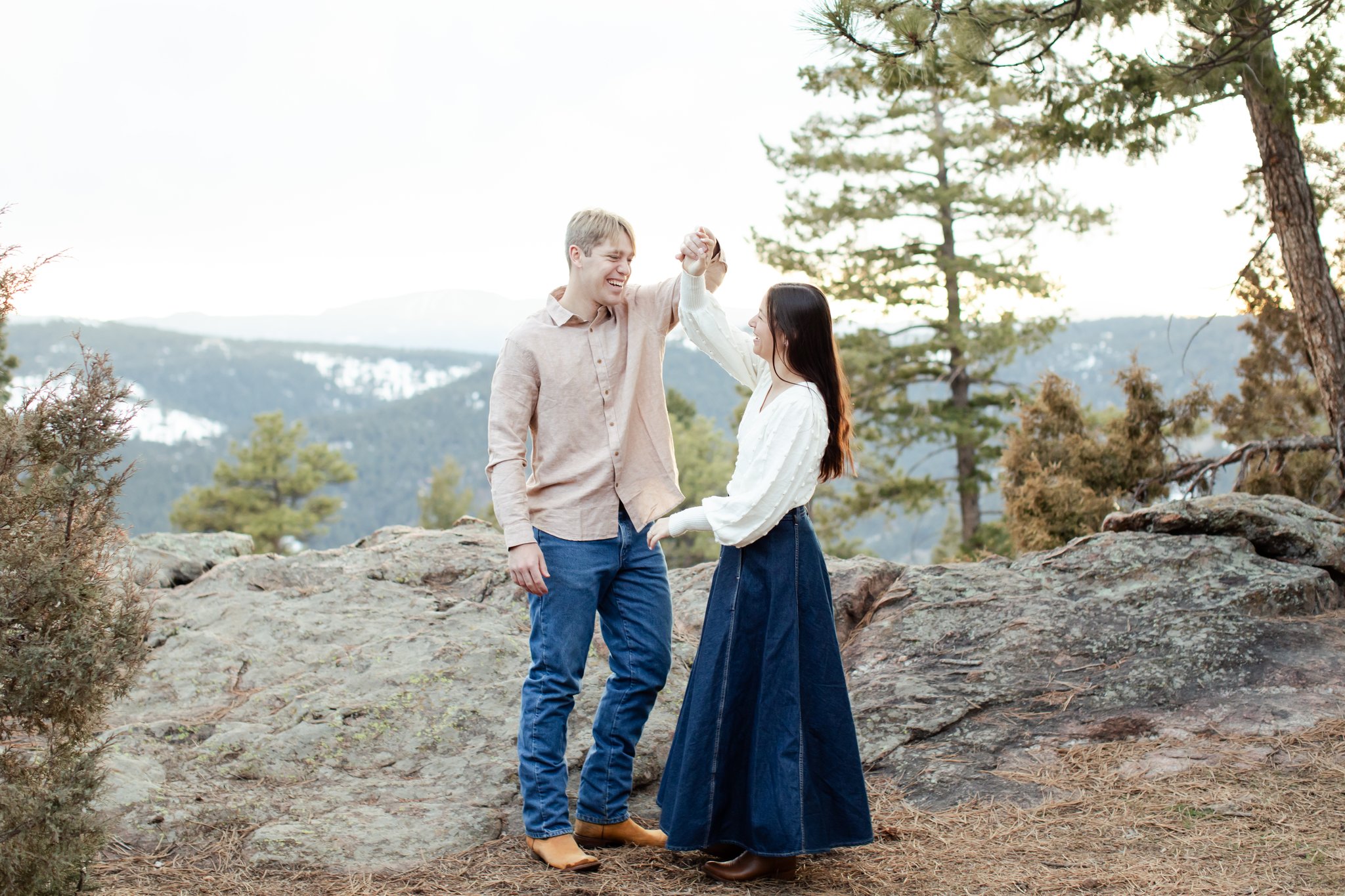 Couple has their last dance of the evening in the mountains as the sun sets.