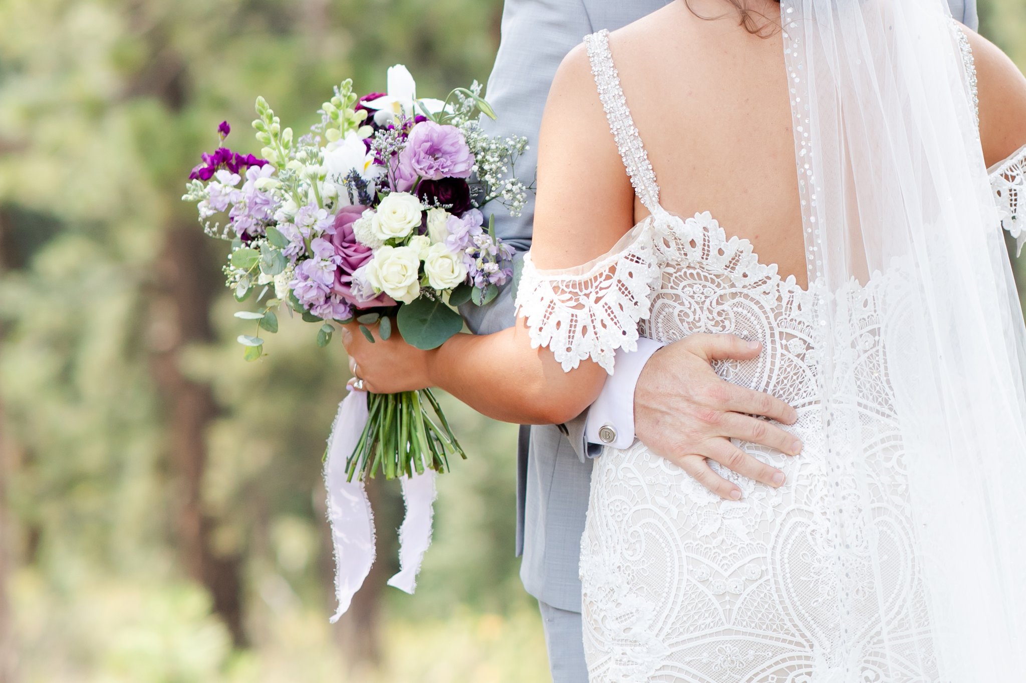 Bride holding her bouquet to show what a real photographer captures at a wedding.