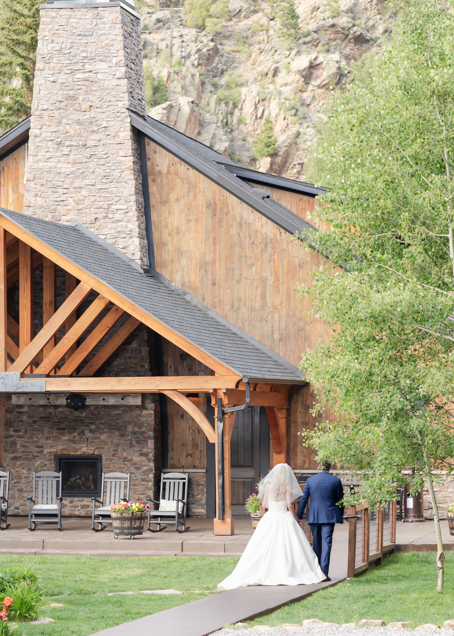 Bride and groom walking away from ceremony at Blackstone Rivers Ranch wedding venue near Denver, Colorado.