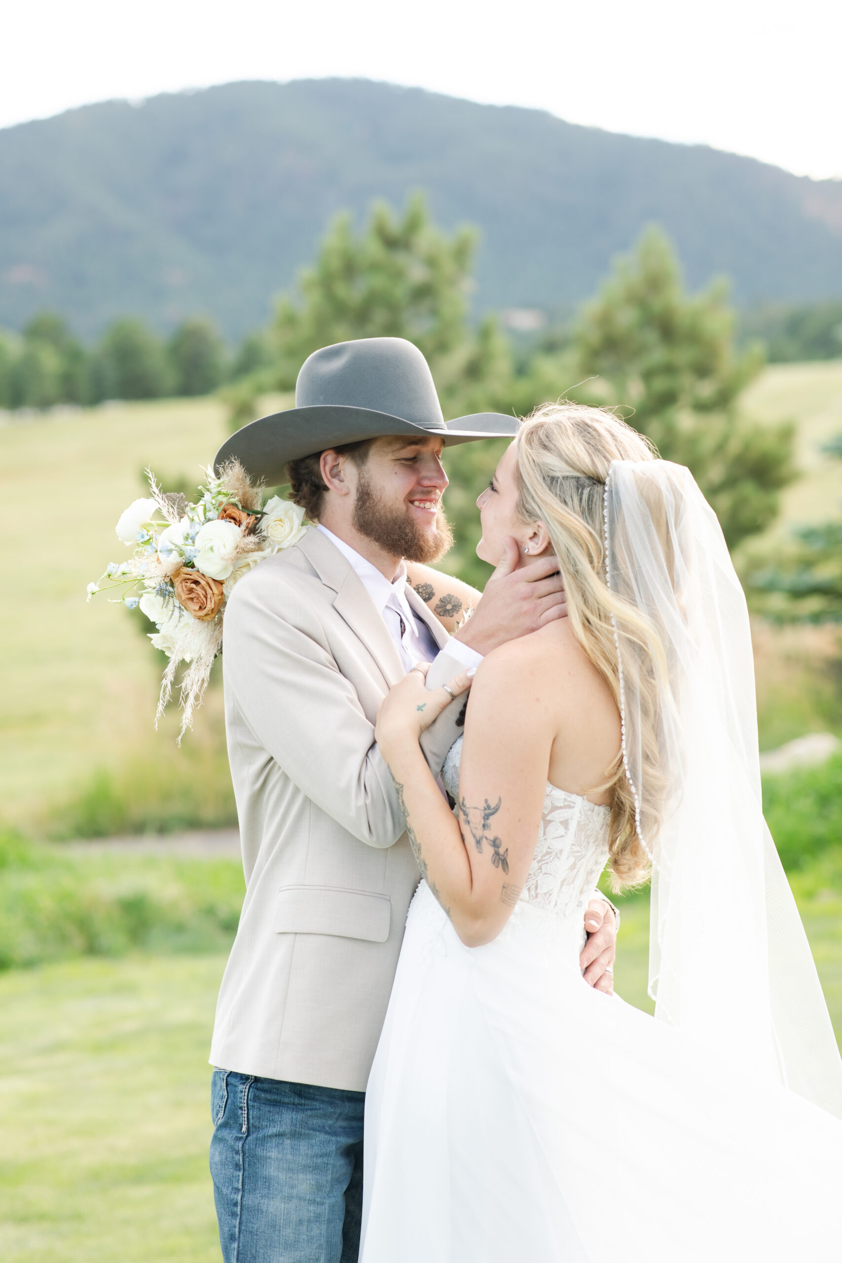 Bride and groom embrace at Spruce Mountain Ranch wedding venue.