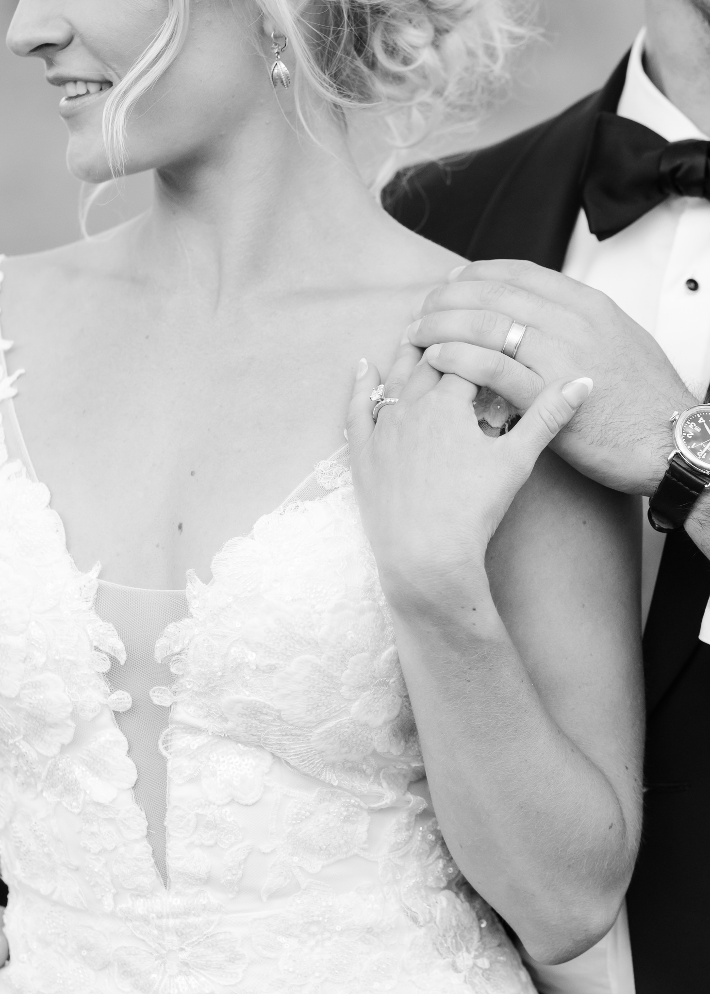 black and white details image of newlyweds hands on bride's shoulder during their day at the Wellshire Wedding Venue